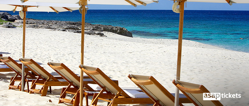 Sunbathing chairs at the beach on vacation - ASAPtickets Travel Guide