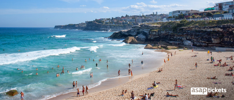 Beach full of people, cheap flights in peak season - ASAPtickets Travel Guide