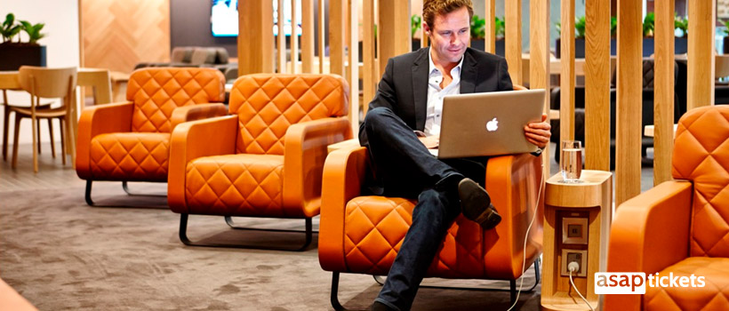 Man with an Apple computer work before flight in Airport's Business lounge - ASAPtickets