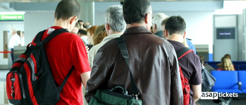 A line of people before boarding in airport - ASAPtickets